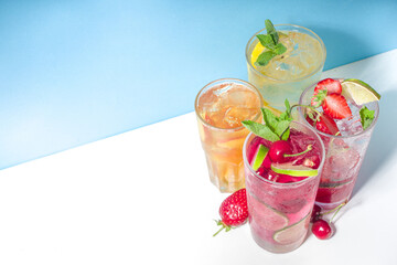 Iced refreshing drink. Bar and caffee beverage menu background. Set of various cold summer cocktails - peach tea, lemonade, mojito, cherry mocktail, with frruits on colorful bright blue background