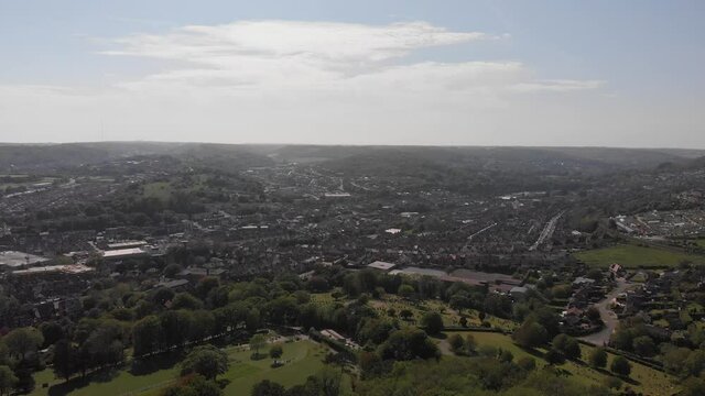A slow drone descent over Dover town in Kent with bright sun and some clouds