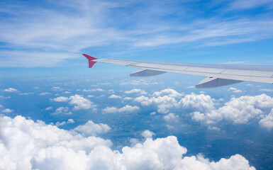 Fototapeta na wymiar Aircraft wings fly on clouds sky