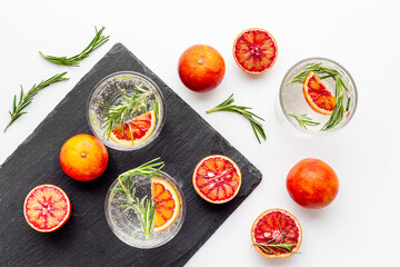 Fototapeta na wymiar Citrus sangria or lemonade with blood red oranges and ice