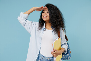 Young african american girl teen student in denim clothes backpack hold books hand at forehead look...