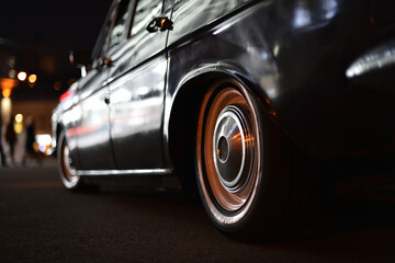 black soviet vintage car close-up on night city street