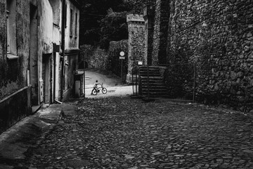 kid with bike at the street of the old town