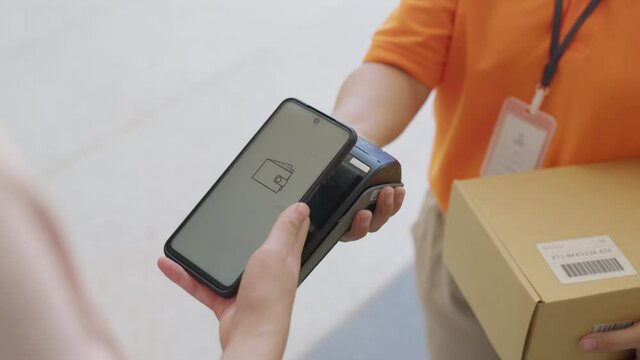 Asia young smile happy woman people receive parcel postal from e-commerce online shop store use tapping cashless wifi qr code nfc bill scan app smart pos device reader in city life home contactless.