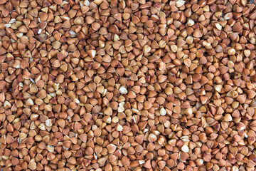 sprinkled buckwheat, raw grain close-up, top view