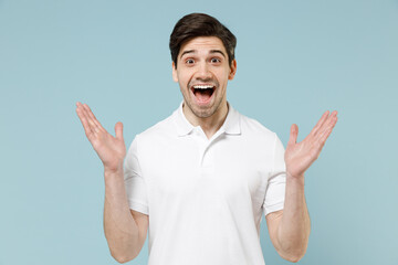 Young fun amazed excited surprised unshaven cheerful caucasian man 20s wear white casual basic...