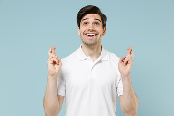 Young unshaven caucasian man 20s in white casual basic t-shirt waiting for special moment, keeping...