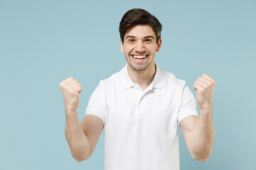 Young fun overjoyed happy unshaven caucasian man 20s wear white casual basic t-shirt do winner...