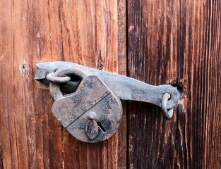 An old rusty lock on a barn in the village