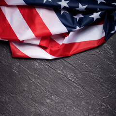 Concept of Independence day or Memorial day. Flag over dark slate table background.