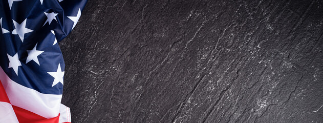 Concept of Independence day or Memorial day. Flag over dark slate table background.