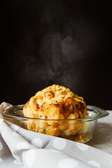 Baked whole cauliflower in a saucepan