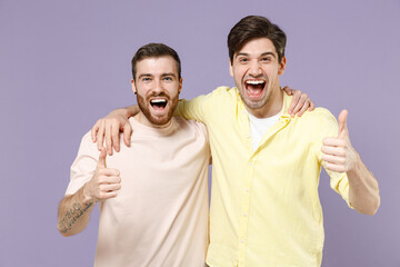 Two young smiling cheerful positive cool men friends together in casual tshirt tattoo translate fun...