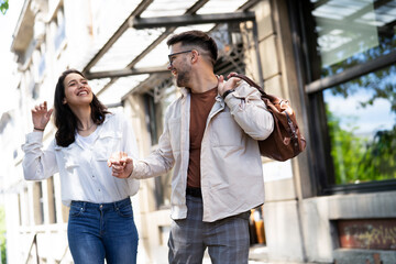 Happy young couple outdoors. Loving couple walking in the city.
