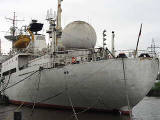 Old ship near the pier of the sea cargo port, the stern of the ship, close-up. Terminal of a sea or...