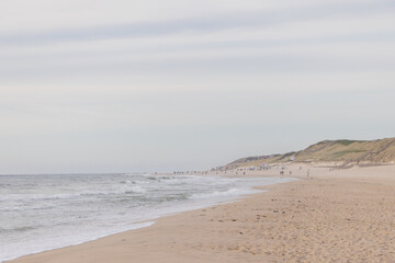 Panoramic view of Sylt Island beach at the golden hour of a cloudy afternoon. 