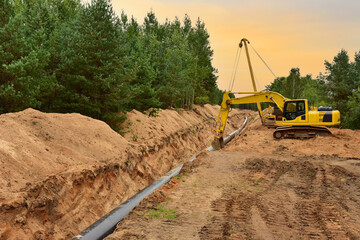 Natural Gas Pipeline Construction. Building of transit petrochemical pipe in forest area. Pipes...