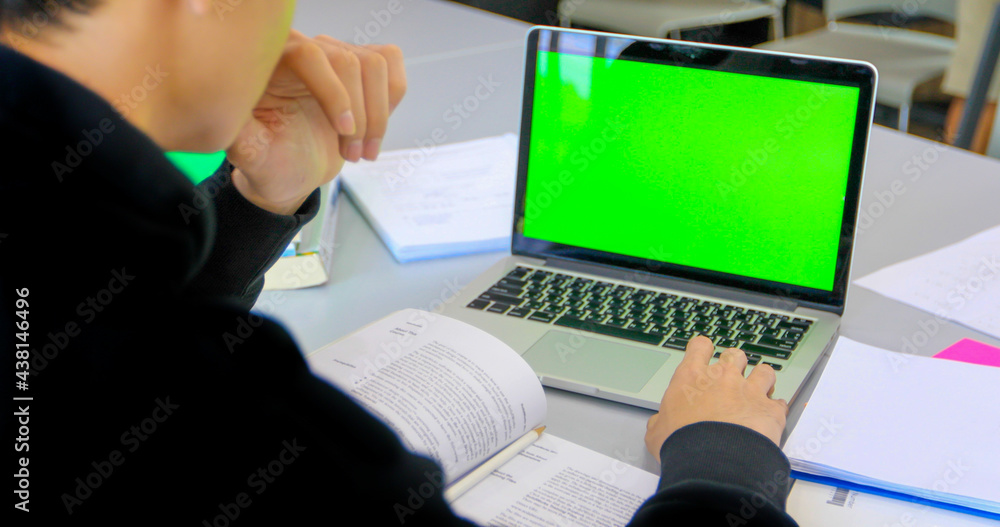 Aufkleber asian students use notebook and tablet computers on green screen to work