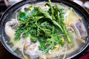 Cod, roe, intestines, vegetables, and bean sprouts boiled in a pot, Korean traditional food,