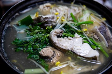 Cod, roe, intestines, vegetables, and bean sprouts boiled in a pot, Korean traditional food,