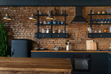 Spacious industrial loft kitchen and living room with vintage decor and black cabinets