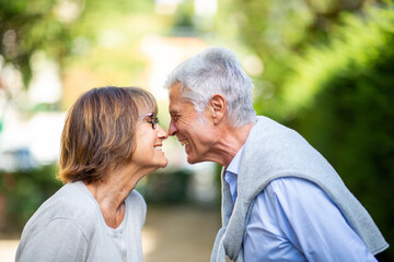 Obraz premium Profile of older couple smiling face to face nose to nose