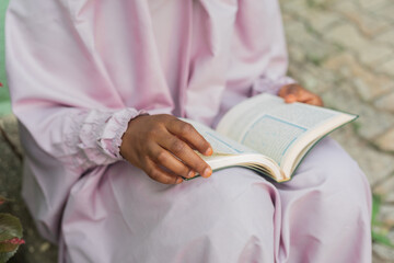 Muslim woman reading the Quran,