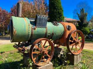 Old steam engine mounted on concrete blocks 
