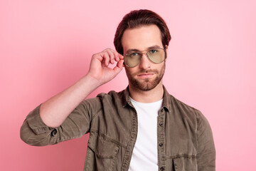 Photo of young handsome man serious confident macho hand touch glasses isolated over pastel color...