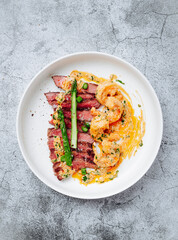 Тop sirloin steak, asparagus, shrimp and shrimp sauce with butter and garlic