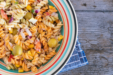 Pasta salad with tuna, egg, tomato, corn and olives