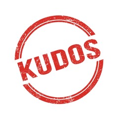 KUDOS text written on red grungy round stamp.