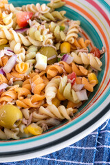 Pasta salad with tuna, egg, tomato, corn and olives