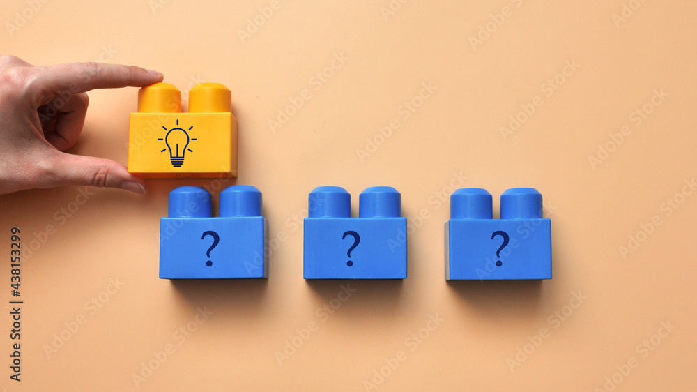 Poster designer with drawings of questions and light bulbs. the symbol of the emergence of questions and th