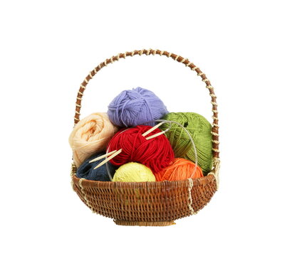 Colorful yarn balls in basket isolated on white