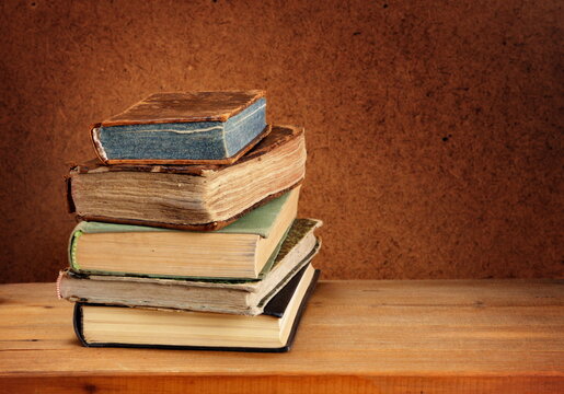 Stack of old books on wooden table