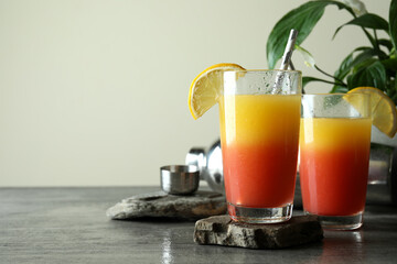 Tequila Sunrise cocktails on gray textured table