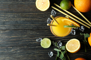 Tequila sunrise cocktail and ingredients on wooden table
