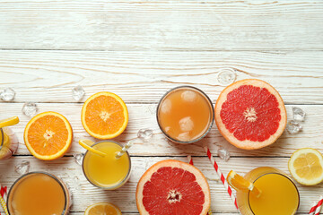 Tequila sunrise cocktail and ingredients on wooden table