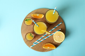 Board with Tequila sunrise cocktail on blue background