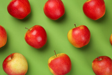 Ripe apples on green background, top view