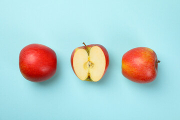 Ripe apples on blue background, top view