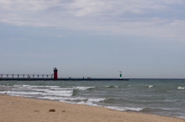 Perspective of two lighthouses on a pier from the beach
