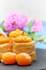 Cakes with egg yolk, flour and sugar with natural plant decoration and blue background.