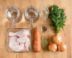 The ingredients for the broth are laid out evenly. Water, carrots, chicken