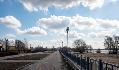Beautiful embankment along the river against the blue sky, spring.