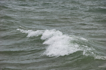 Turquoise white cap wave coming into shore