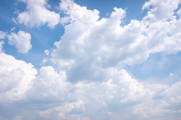 Naklejka na ściany i meble Large white clouds against the blue sky.