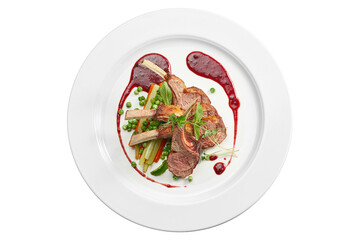 Appetizing grilled rack of lamb with vegetables and berry sauce in a white plate. Isolated on white...