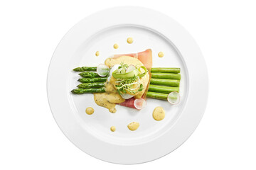 Delicious breakfast asparagus with poached egg, bacon, hollandaise sauce in a white plate. Isolated on white background. View from above